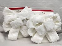 Two Celebrate It white faux fur bows on cards front view