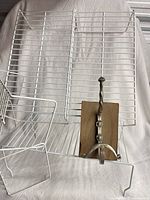 Front view of wire risers with metal hook resting on one riser