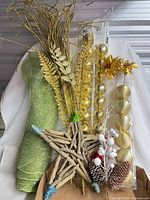 All items grouped: driftwood star, ribbon, gold picks, ornament packs, pinecone pick