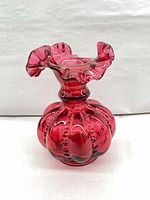 Front view of cranberry ruffled Fenton vase showing overall form