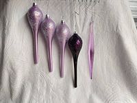Front view of five teardrop and one icicle ornaments showing color and glitter finish