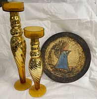Pair of amber glass candlesticks and Hubert de Roscoat plate grouped together