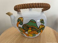 Side view showing mushroom graphics and wicker handle