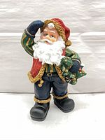 Full view of painted resin Santa Claus figurine