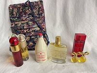 Group shot of all perfumes, colognes and fabric pouch