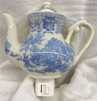 Blue and white porcelain teapot night light plugged into display