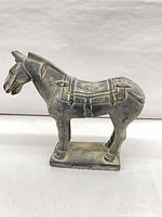 Left profile of terracotta horse on base