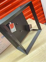 Overall view of square flush-mount light showing black frame and chrome lamp holder