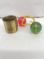 Metal slinky and clackers side by side