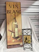 Full view of wooden Vin Blanc wall art and metal wine rack