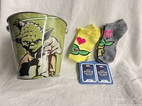 Overall view of Yoda tin, two sock pairs, two Marvel card packs