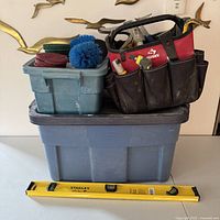 Overall lot showing totes, tool bag, level and cleaning pads