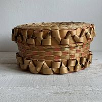 Angled view showing complete basket with lid and porcupine curl decoration