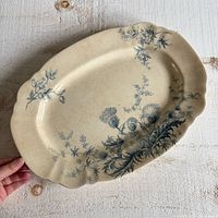 Full view of oval platter showing blue thistle pattern and cream ground