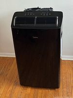 Front view of black Midea Duo portable air conditioner