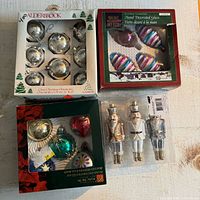 Four boxed/tray sets of ornaments grouped together