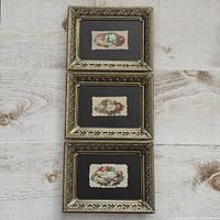 Three ornate gold-tone filigree frames, each with centered Victorian valentine card
