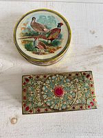 Both tins side by side showing size and design comparison
