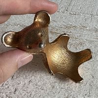 Front view of gold-tone bear gum holder