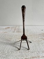 Front view of bent fork easel standing upright, showing overall shape