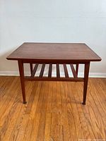 Full view of rectangular wood side table with slatted shelf