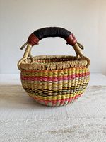 front view of woven basket showing color pattern and handle