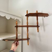 front view of three-tier wooden wall shelf
