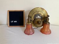 Fixture disassembled showing canopy, shades, sockets