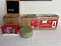 Full lot showing boxed tree, Yankee Candle gift set, candy-cane tin
