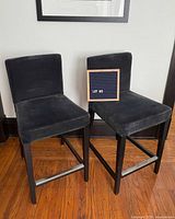 front view of both charcoal velvet counter stools showing design and material
