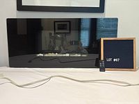 Front view of fireplace with cord and remote