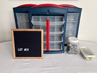 Front view three Mastercraft organizers, jar of screws, container of nails