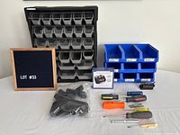 Overall view showing Husky organizer, blue stackable bins, boxed wrist band, bag of vacuum attachments, screwdrivers, bit set