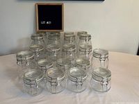 Front view of 22 IKEA glass jars in three sizes