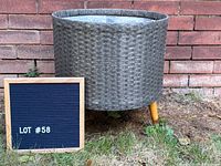 front view of wicker planter showing legs and weave