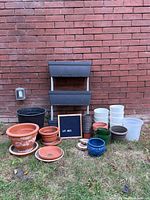 Full lot against brick wall showing all planters and pots