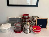 Group shot of all items: spice racks, bowls with lids, mixing bowls, salad spinner, tupperware