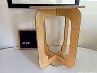 side view of fully assembled plywood side table showing curved legs and base