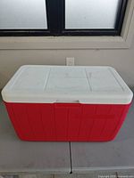 Front view of red cooler with white lid