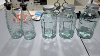 Front view showing all five aqua glass containers lined up