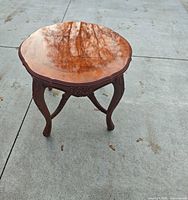 Full view of round carved wood side table