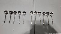 All 11 soup spoons arranged to show full set