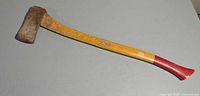 Full view of axe showing head, handle, red grip end