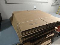 Stack of flat-packed corrugated boxes strapped together