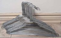 Stack of silver galvanized wire hangers side view