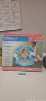 Front view of boxed SwimSchool Splash Mat showing product image and features