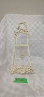 front view of cast iron easel showing scrollwork and finish