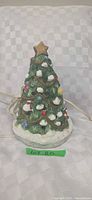 Front view of ceramic Christmas tree with cord and star topper