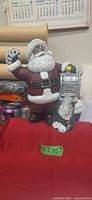 Front view of resin Santa figurine with cards and slot machine