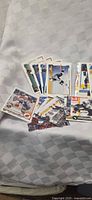 Spread of assorted hockey trading cards on white cloth